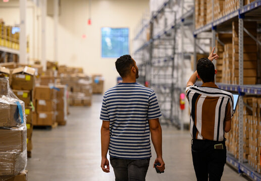 Managers meeting in warehouse with Laptop notebook 