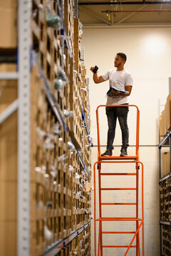 Man Picking Product at E-Commerce Warehouse