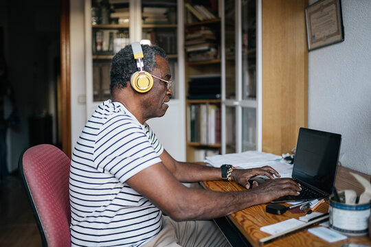 Pensioner man using laptop