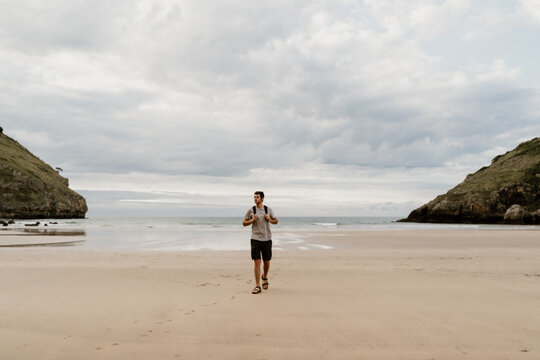 Man walking on empty wild beach