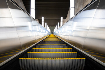 A receding empty modern escalator in the subway. Linear perspective.