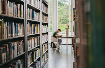 A man sitting and reading in library
