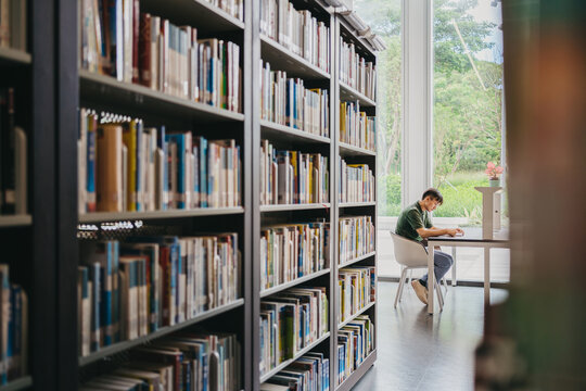 A man sitting and reading in library