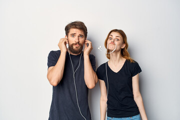 Man and woman in black t-shirts phone fun together friendship isolated background