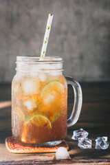 ice lemon tea in the glass with lime slices