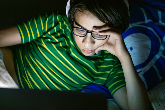 Teen watching flick at night