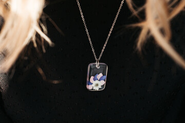 woman wearing floral epoxy necklace 