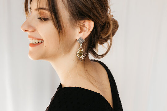 woman wearing floral epoxy earrings 