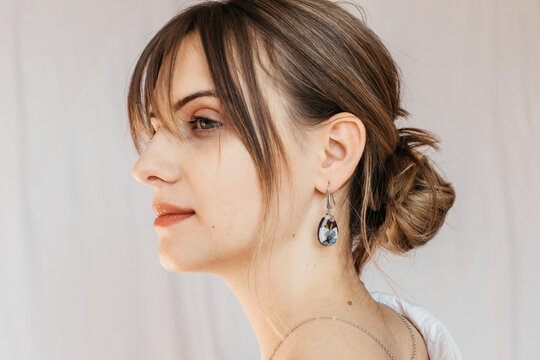 woman wearing floral epoxy earrings 