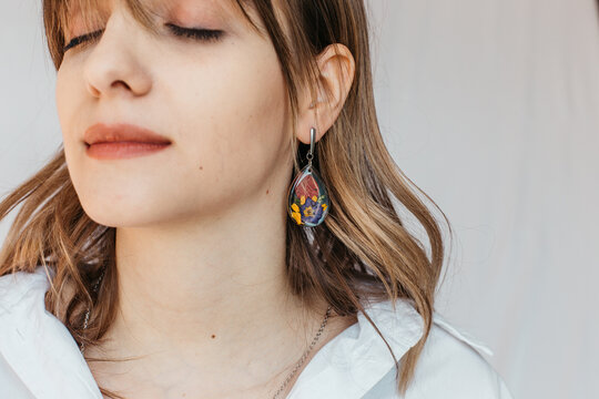 woman wearing floral epoxy earrings 