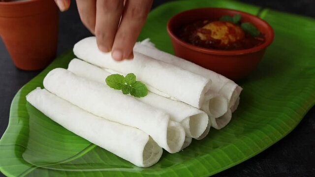 Rice Pathiri pathir flat bread spicy chicken curry woman hand serving traditional South Indian breakfast dish Rice roti 4K video footage Malabar Ramadan Ramzan, Eid festival Kerala India SriLanka