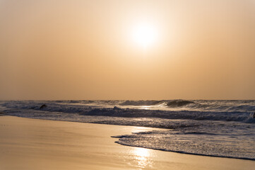 Waving sea washing sandy beach