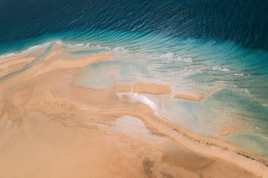 Sandy beach near azure ocean in Spain