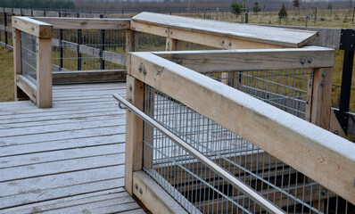 observation tower platform made of oak logs with barrier-free access for seniors and the immobile. zoo safari with a large paddock and terrace for tourists