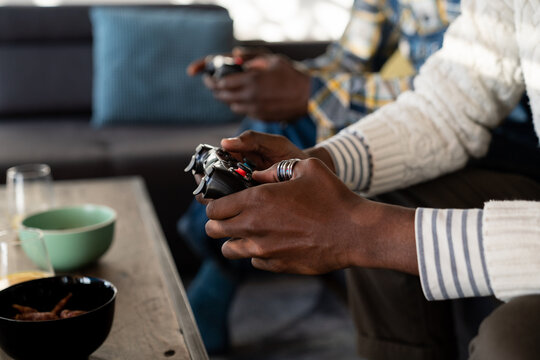 Anonymous Men Holding Gaming Consoles Indoor 