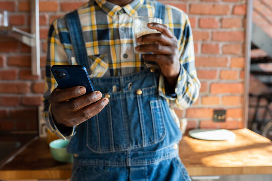 Anonymous Man Using Phone While Drinking Coffee