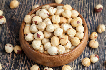 peeled and roasted hazelnuts on a wooden table