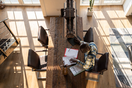 Man Studying Documents At The Table