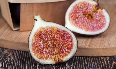 ripe purple figs on a wooden table