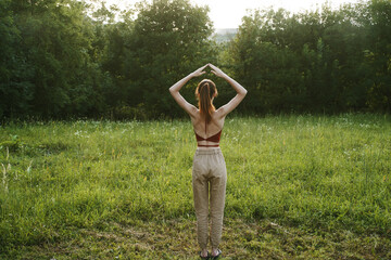 woman in a field outdoors summer meditation fresh air