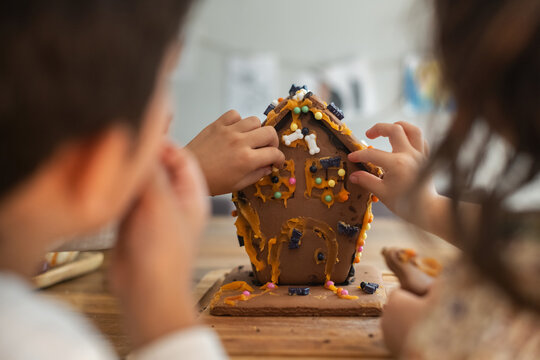 Kids making and eating haunted gingerbread house