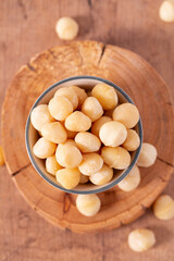 macadamian nuts on dark wooden surface