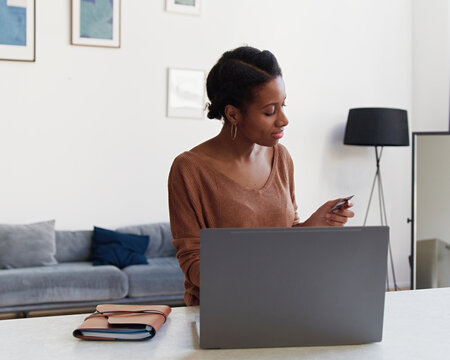 Young African Woman Shopping Online With Bank Card