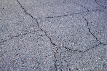 Obraz premium Multiple Cracks on Asphalt