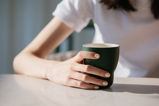 Woman hand holding a coffee cup