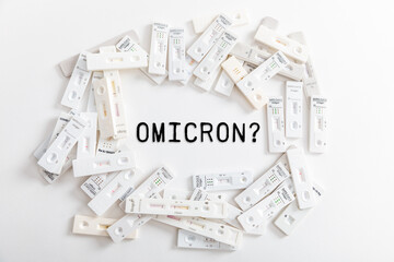 Covid Rapid antigen tests on white background with text omicron
