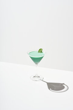 Green cocktail with mint garnish