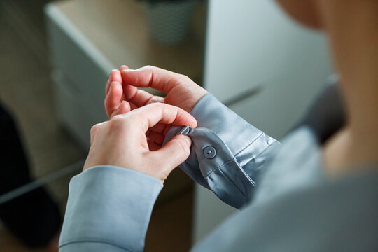 Woman getting dressed in shirt