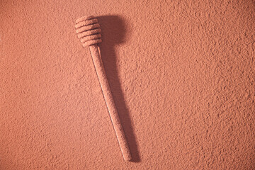 Spoon for a set of honey is sprinkled with cocoa.