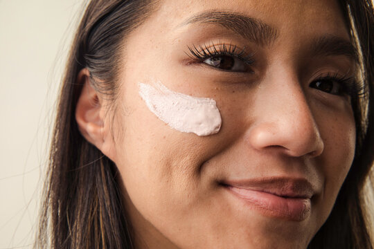 Woman with Scrub on her cheekbone smiling