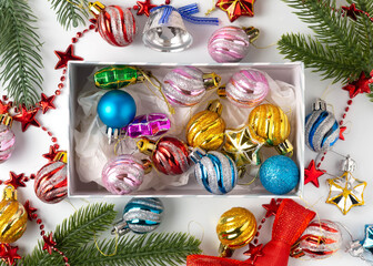 A large set of colorful Christmas decorations for the Christmas tree, pine, spruce. Balls, bells in a box.
