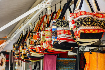 Fototapeta na wymiar Selective focus. Traditional Turkish colorful handbags on store in bazaar market in Turkey