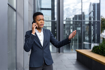 Serious and nervous business woman with glasses, African American woman with short haircut talking...