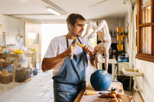 Concentrated artisan working in workshop