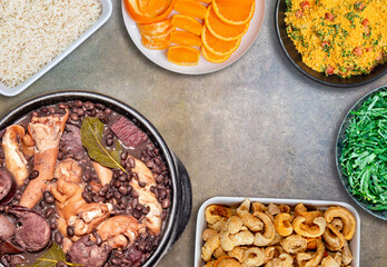 Genuine Brazilian feijoada food over rustic table in top view