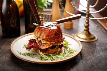Kosher mutton burger with pastrami and cheese.
Culinary photography. Suggestion to serve the dish.