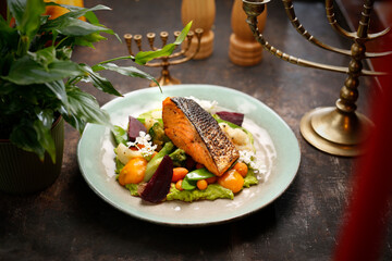Grilled salmon on vegetables. A dish of Jewish cuisine.
Culinary photography. Suggestion to serve the dish.