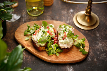Toasts with cottage cheese and green salad.
  Jewish kosher dish.
Culinary photography. Suggestion to serve the dish.