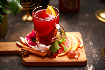 Winter raspberry tea with cymammon, fruit and anise.
A glass with a warming infusion. Culinary photography.
