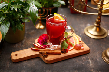Winter raspberry tea with cymammon, fruit and anise.
A glass with a warming infusion. Culinary photography.