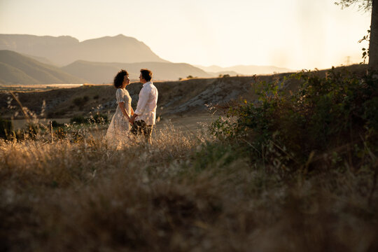 Lovely Couple In The Field At Sunset