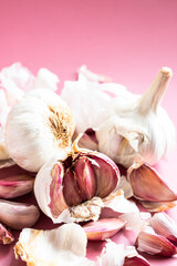 Garlic glove on colour background. Close up of detail. Modern food condiment.