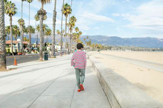 Young tourist walking by the beach area