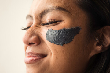 Model with grey face scrub smiling cute