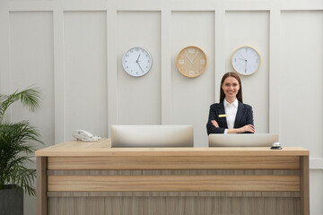 Portrait of beautiful receptionist at counter in hotel
