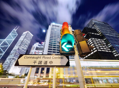 Traffic lights and the skyline of Hong Hong at night. 